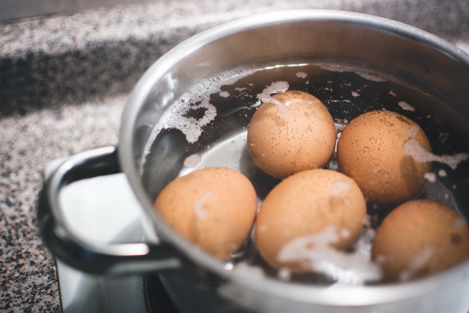 Eggs boiling in a pot on the stove