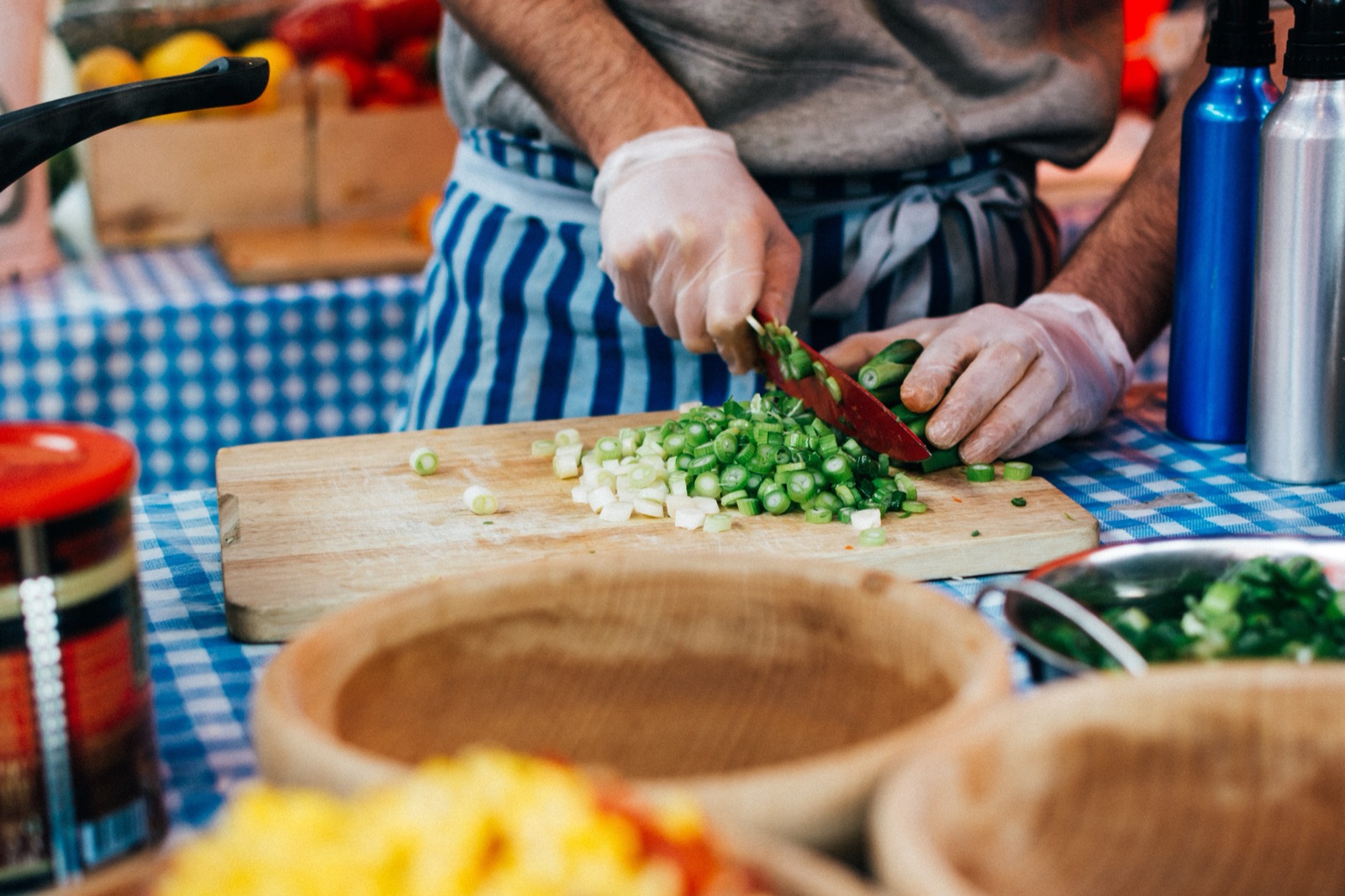 Fresh spring onion being chopped on a cutting board